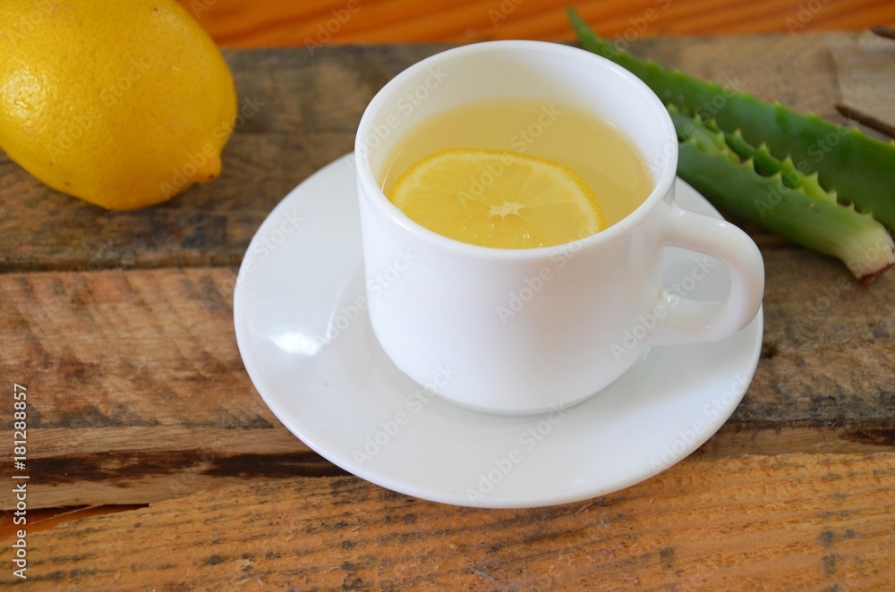 Drink with aloe vera and lemons. Glass cups on wooden background Drink with aloe vera and lemons. Glass cups on wooden background