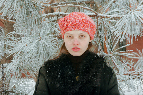 Young beautiful girl shows the photographer part of her young body. A wolfskin jacket. photo