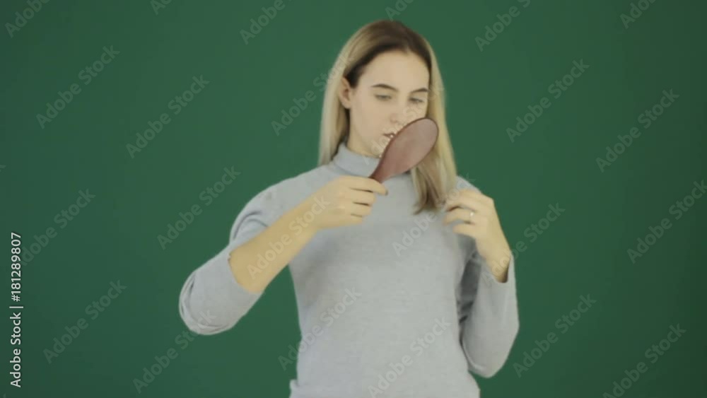 Young cute girl with hairbrush, chromakey  