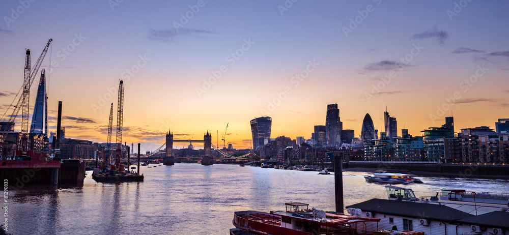 Fototapeta premium London skyline at colourful sunset including Tower Bridge and skyscrapers at financial district