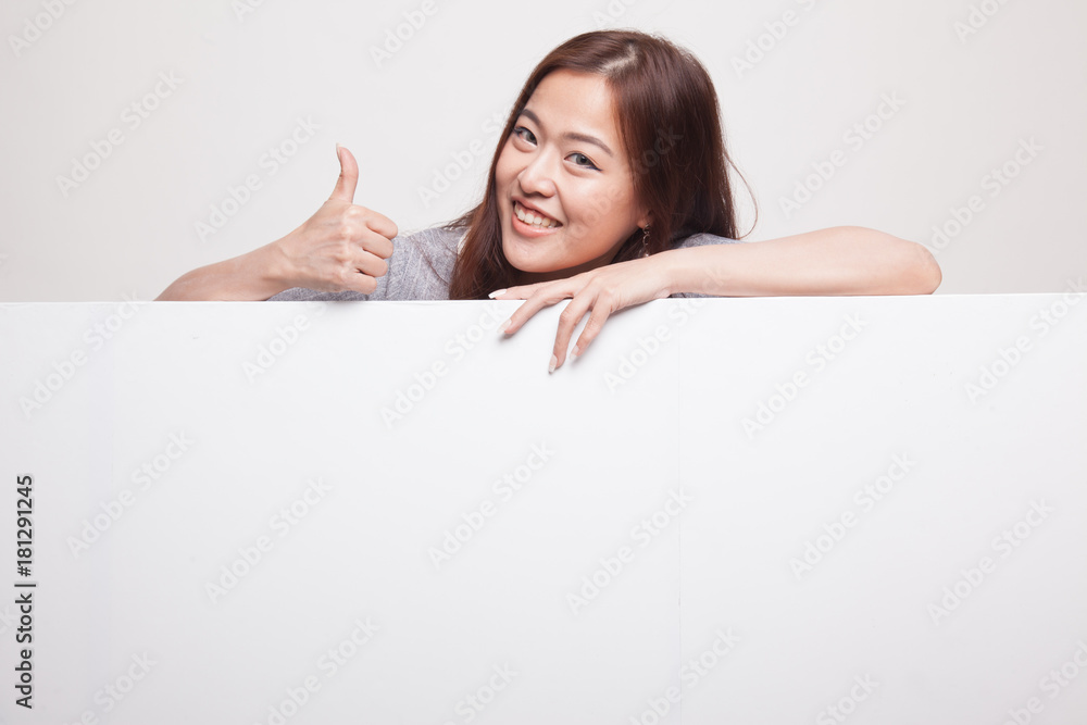 Young Asian woman show thumbs up with blank sign. Young Asian woman show thumbs up with blank sign.