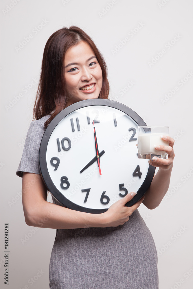 Healthy Asian woman drinking glass of milk hold clock. Healthy Asian woman drinking glass of milk hold clock.