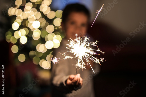 Child holding a small firework