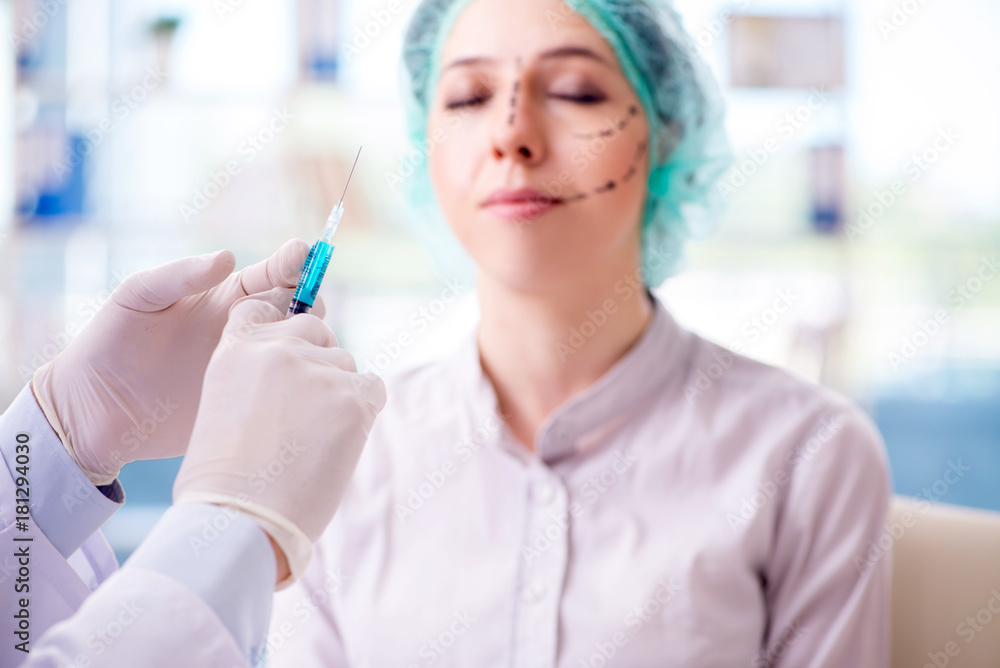 Plastic surgeon preparing for operation on woman face Plastic surgeon preparing for operation on woman face