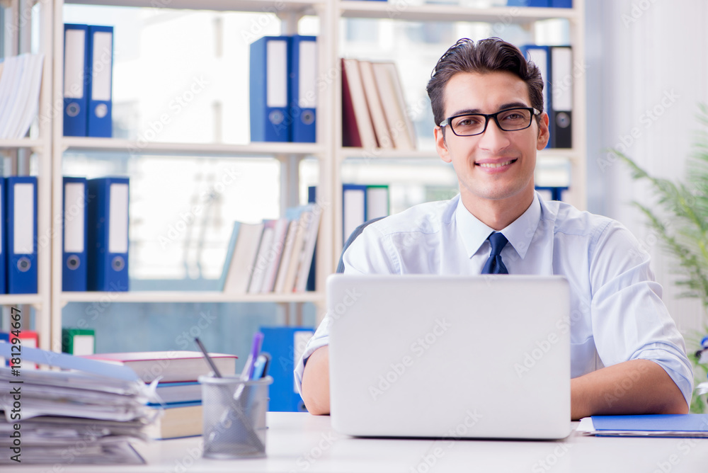 Businessman with excessive work paperwork working in office Businessman with excessive work paperwork working in office