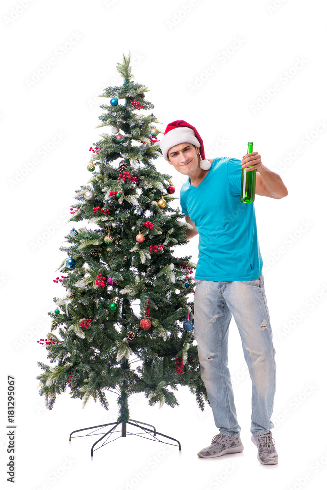 Young man decorating christmas tree isolated on white Young man decorating christmas tree isolated on white