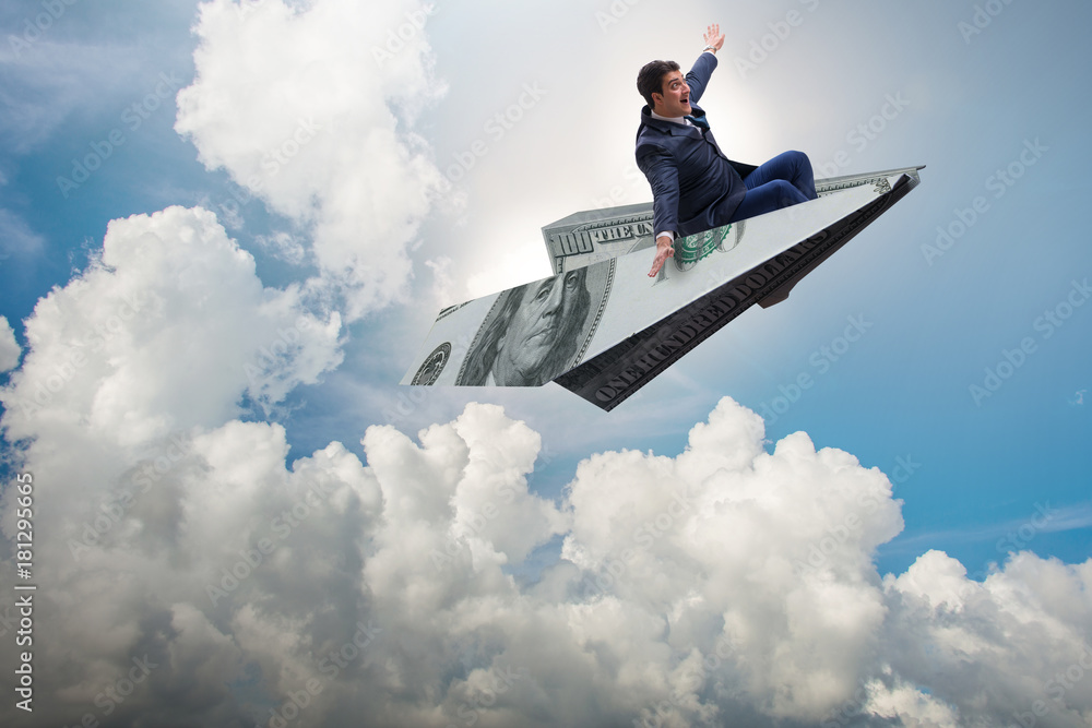 Businessman flying on paper plane in business concept Businessman flying on paper plane in business concept