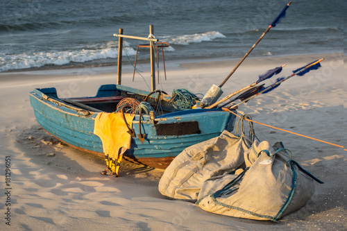 Fishing boat on a beach during sunset. Baltic Sea and the Hel Peninsula in Kuźnica, Poland.	