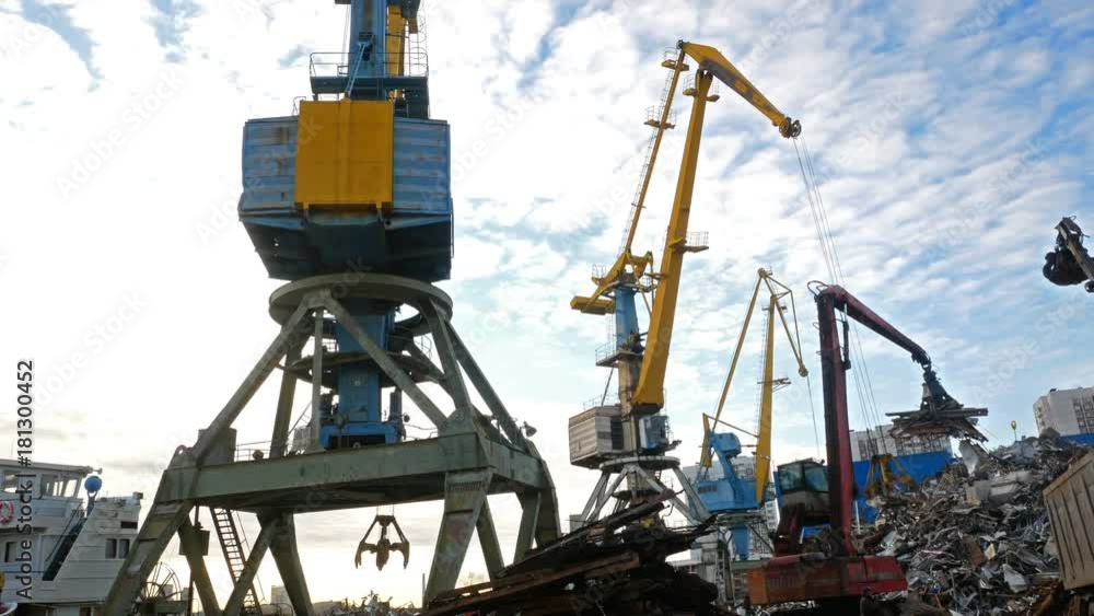 River port cranes load scrap metal into wagons River port cranes load scrap metal into wagons