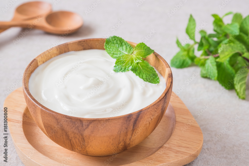 Yogurt in wooden bowl Yogurt in wooden bowl