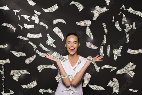girl with a lot of money around her falling trom above and big spender concept