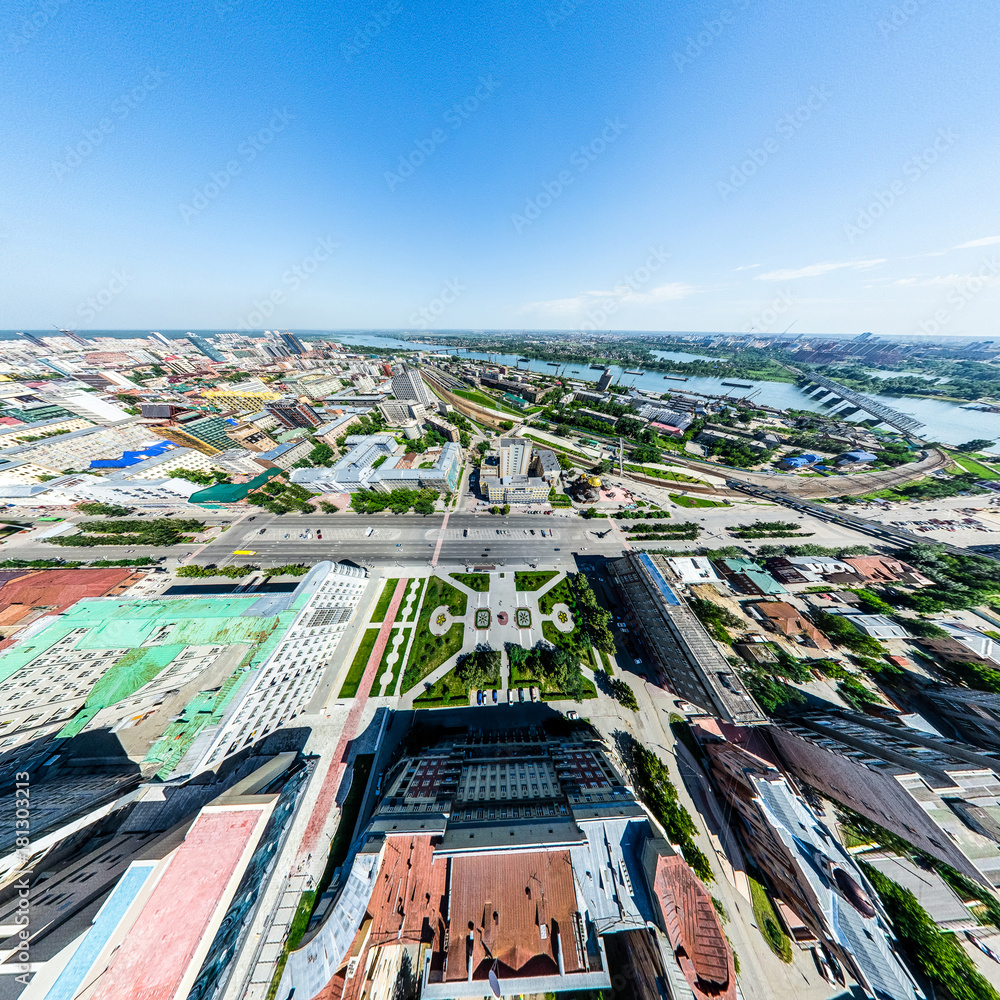 Fototapeta Aerial city view with crossroads and roads, houses, buildings, parks and parking lots, bridges. Helicopter drone shot. Wide Panoramic image.