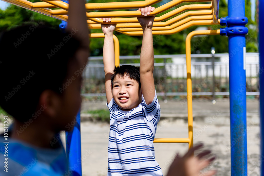 Obraz premium Young asian boy hang out door playground