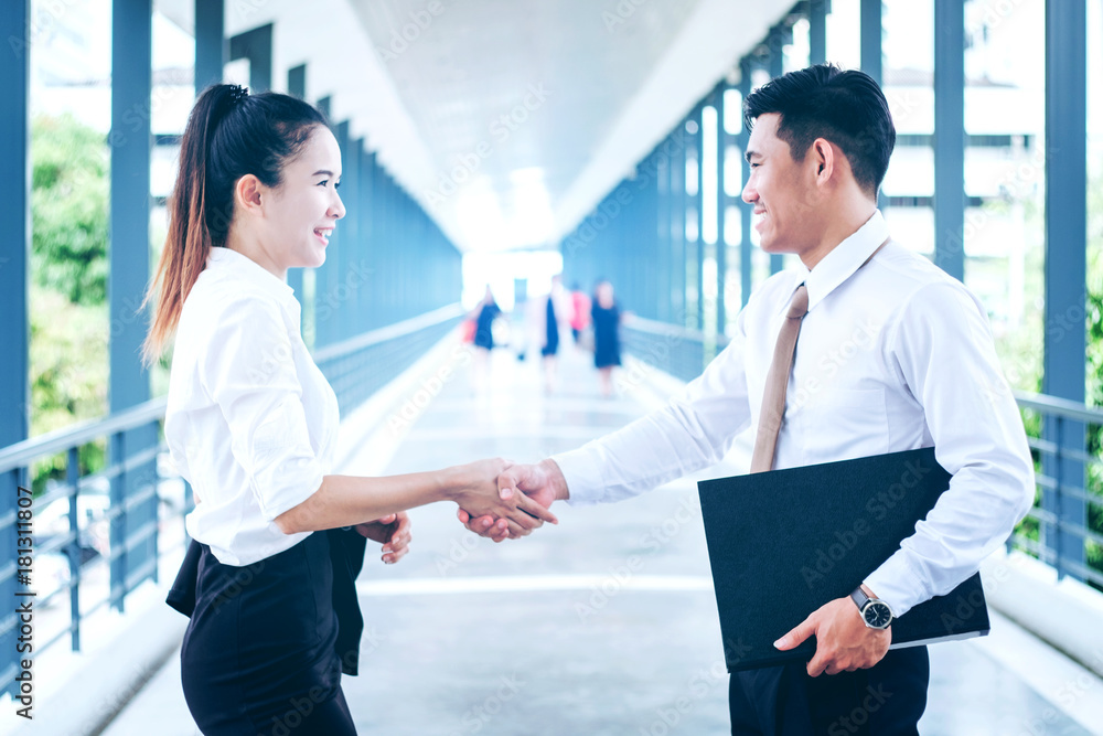 Business partnership handshaking after striking deal outdoors at meeting Business partnership handshaking after striking deal outdoors at meeting