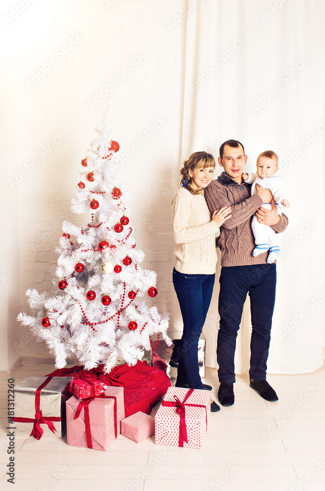 christmas, x-mas, family, people, happiness concept - happy parents playing with pretty baby boy christmas, x-mas, family, people, happiness concept - happy parents playing with pretty baby boy
