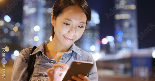 Photography Woman use of smart phone in the city at night