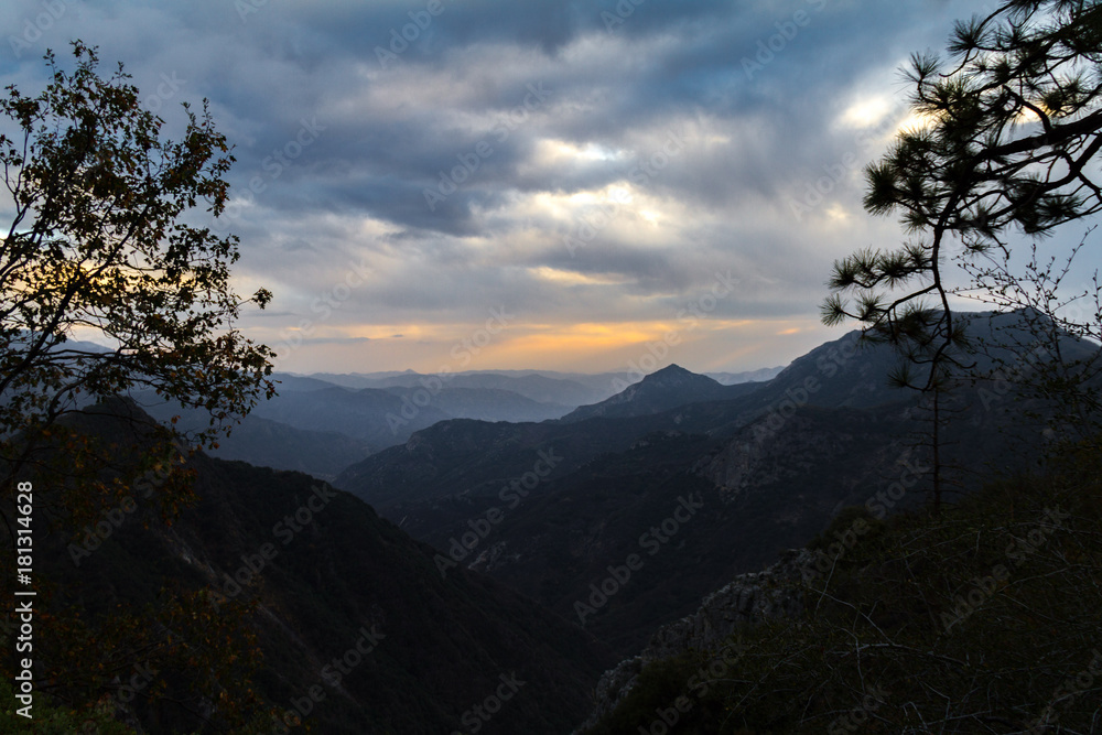 Sunset view bookended by streets of Sequoia and Kings Canyon National Park after a storm. Sunset view bookended by streets of Sequoia and Kings Canyon National Park after a storm.