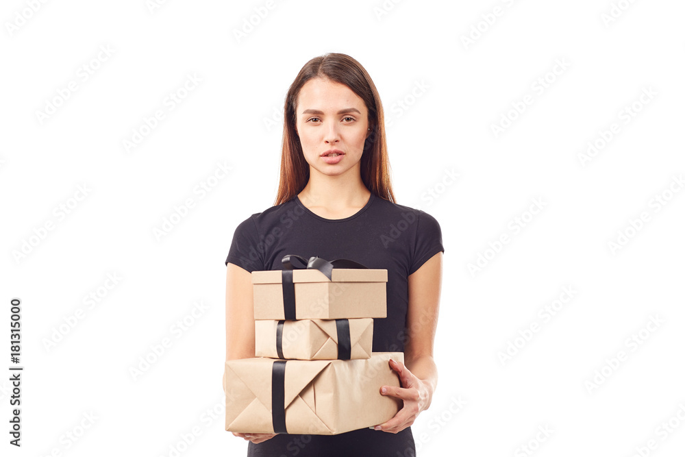 Young woman in black holding stack of gift boxes with black ribbon Young woman in black holding stack of gift boxes with black ribbon