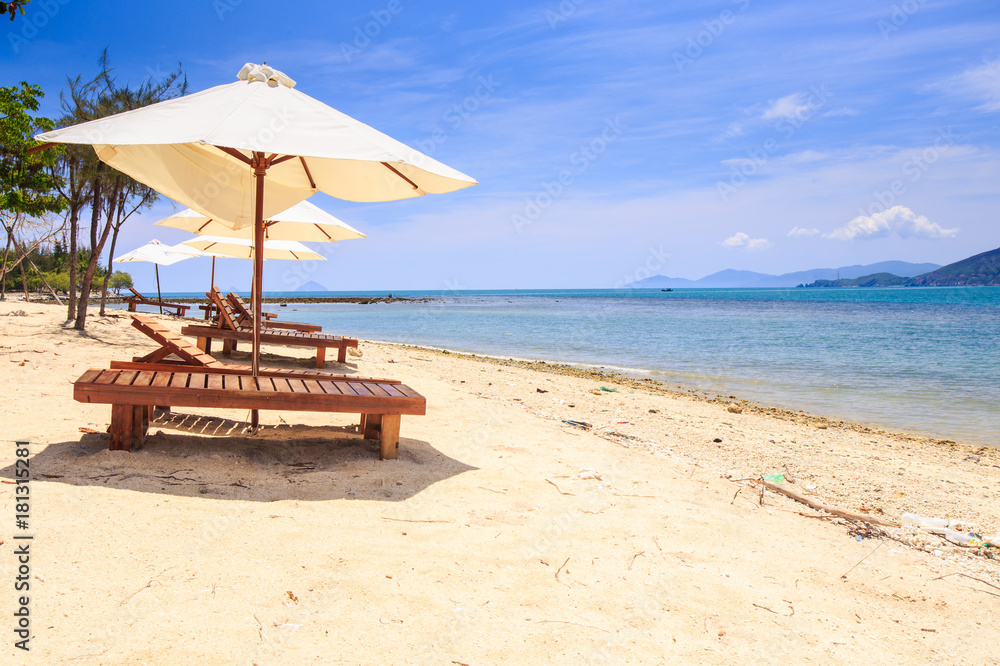 Chairs under White Umbrellas on Sand Beach by Sea