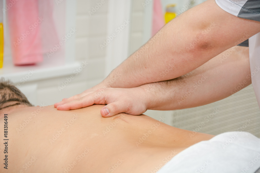 Fototapeta premium Men's massage. The man does massage. Massage by hands.