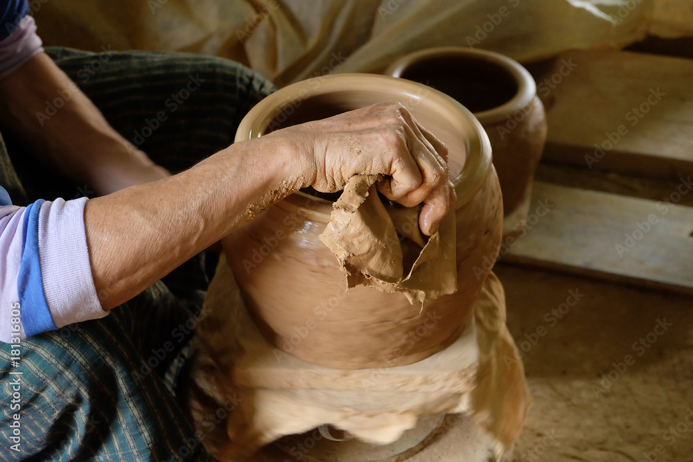 Close up hands working on pottery wheel