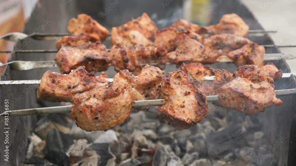 Cooking of pork skewers on metal skewers on coals outdoors. Close up Cooking of pork skewers on metal skewers on coals outdoors. Close up