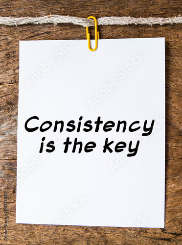 The words consistency is the key on background 