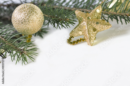 An empty sheet of paper is decorated with Christmas-tree golden toys