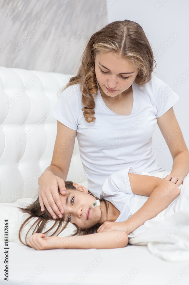 Mother touches the forehead of the child, checking the temperature Mother touches the forehead of the child, checking the temperature