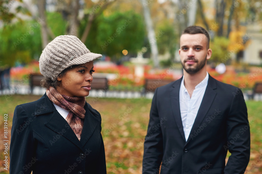 Interracial couple walking in autumn Park . Love and relationship Interracial couple walking in autumn Park . Love and relationship