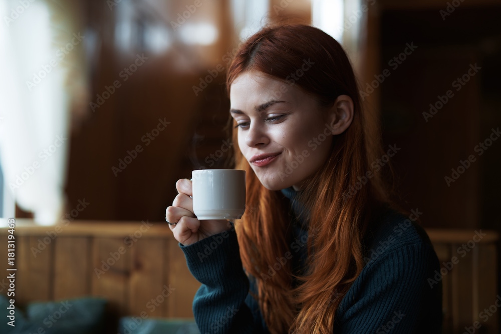 Beautiful young woman drinks coffee in a cafe Beautiful young woman drinks coffee in a cafe