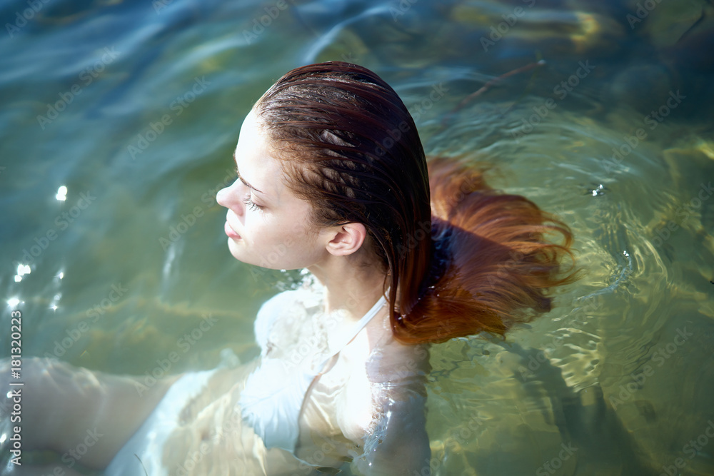 Beautiful young woman is resting on the sea, ocean, beach, sun, summer Beautiful young woman is resting on the sea, ocean, beach, sun, summer