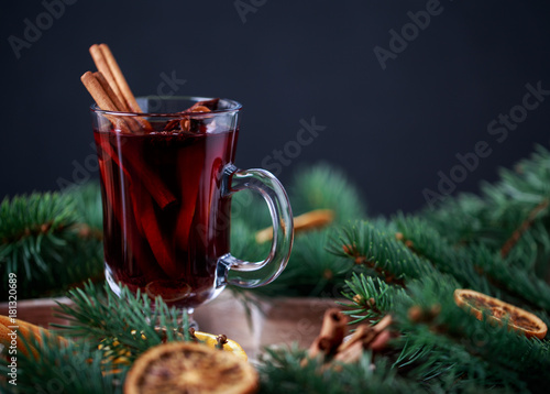 Christmas hot mulled wine in a glass with spices and citrus fruit. Mulled wine with cinnamon, anise and orange