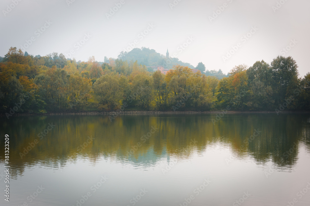 Fall Trees and Lake Reflection on a Foggy Morning Fall Trees and Lake Reflection on a Foggy Morning