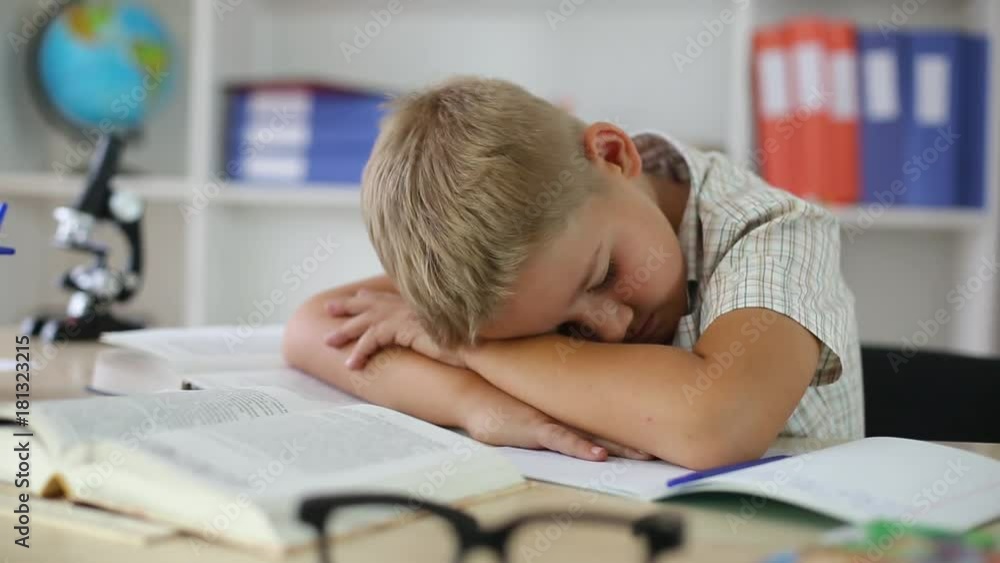 schoolboy was tired and fell asleep at Desk at school, closeup schoolboy was tired and fell asleep at Desk at school, closeup