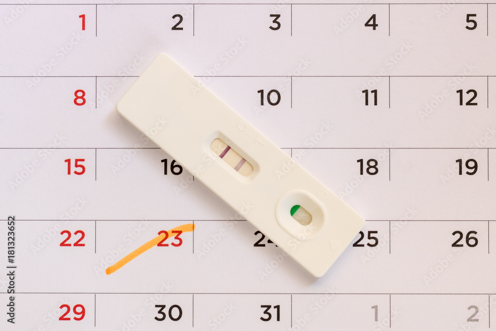 Pregnancy test on calendar background. Pregnancy care concept. Pregnancy test on calendar background. Pregnancy care concept.