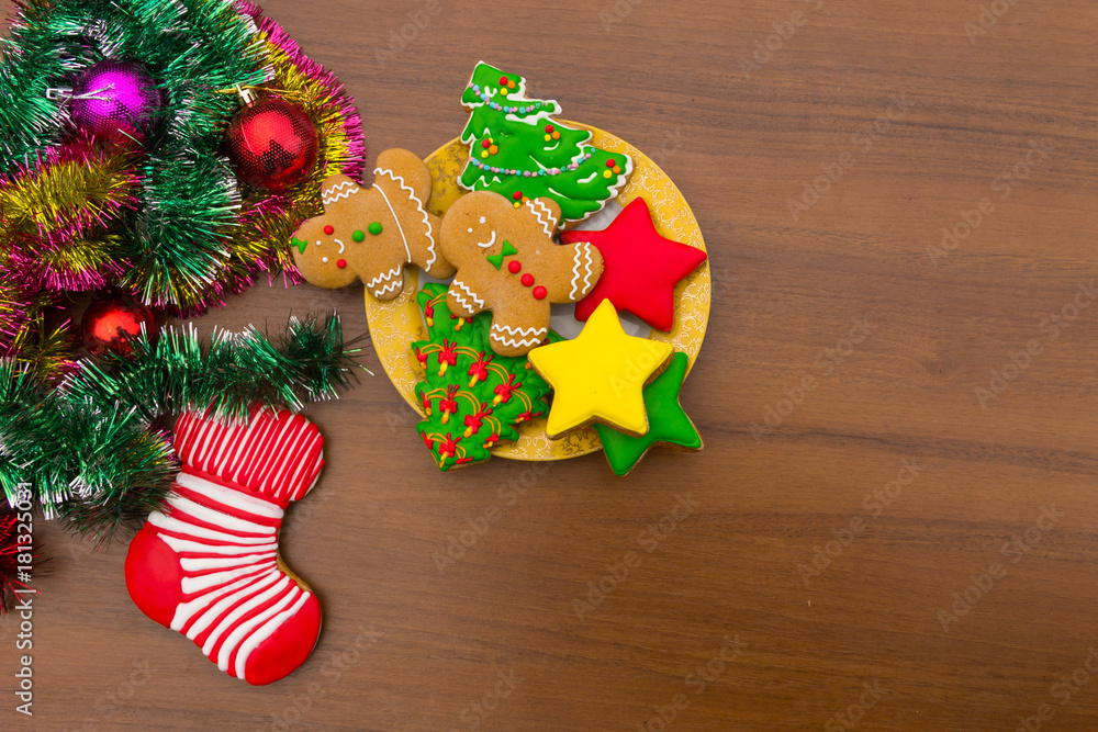 Plate with tasty Christmas cookies on wooden table