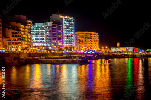 night view of beautiful european city Sliema with seafront and reflection in water, Malta © Alisa