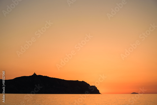 People enjoy Sunset on Bazia beach  Falcone  Sicily. In the background the sanctuary of Tindari