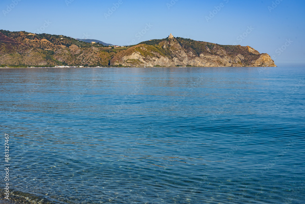 Crystal clear sea water, Bazia beach, Falcone, Sicily. In the background the sanctuary of Tindari Crystal clear sea water, Bazia beach, Falcone, Sicily. In the background the sanctuary of Tindari