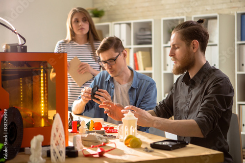 Obraz na plátně Group of young engineers carrying out quality inspection of prototype made with