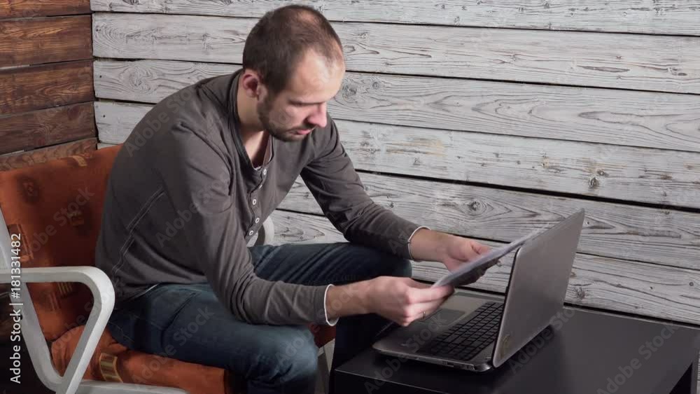 a young man with laptop receiving negative news, upset and surprised a young man with laptop receiving negative news, upset and surprised