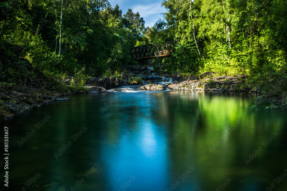 A beautiful river with small watefalls and bridge