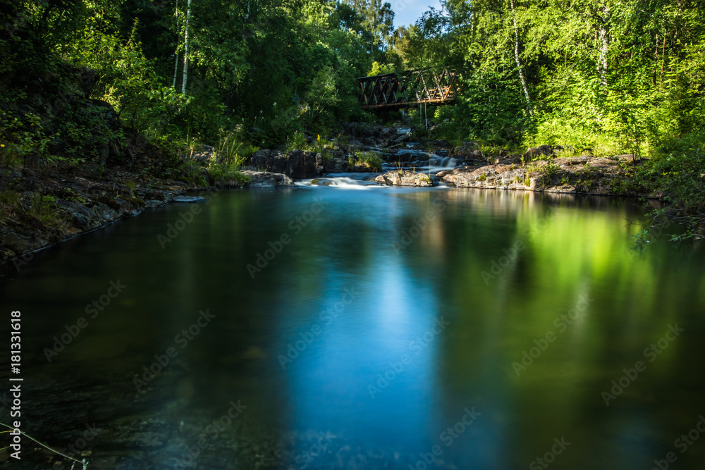 A beautiful river with small watefalls and bridge A beautiful river with small watefalls and bridge