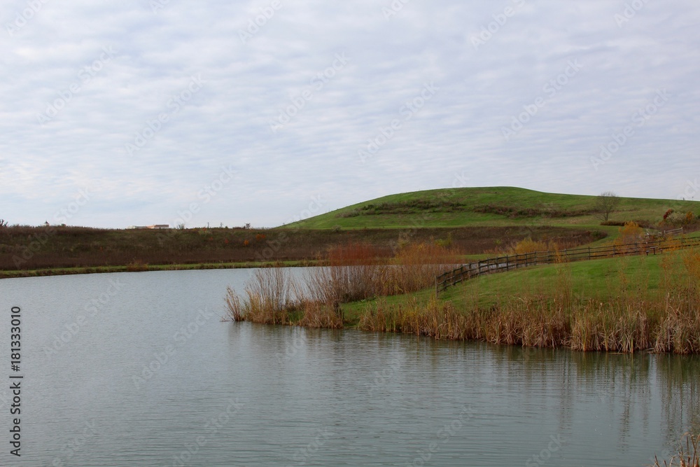 A view of the lake and the hill landscape in the background.