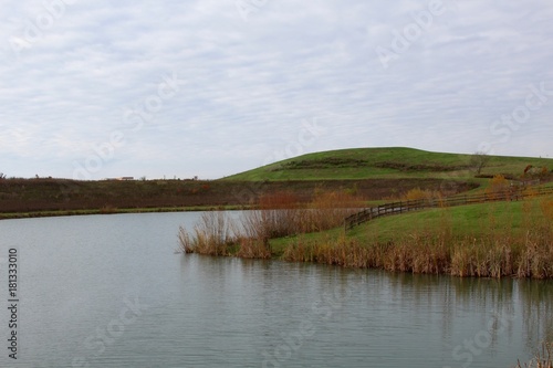 A view of the lake and the hill landscape in the background.