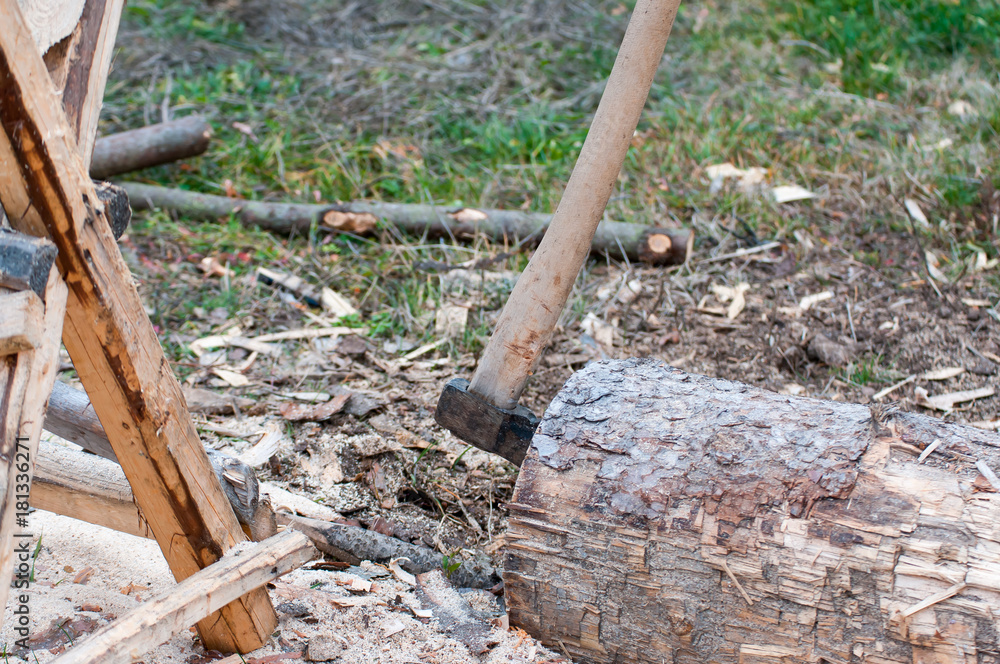 Axe in a pine log, pine sawhorse, focus on the axe. Axe in a pine log, pine sawhorse, focus on the axe.