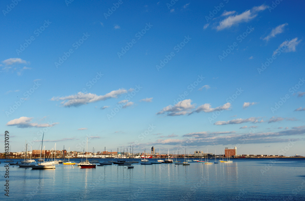 Boston Harbor at late afternoon. Boston Harbor is a natural harbor and estuary of Massachusetts Bay, and adjacent to the city of Boston, Massachusetts.