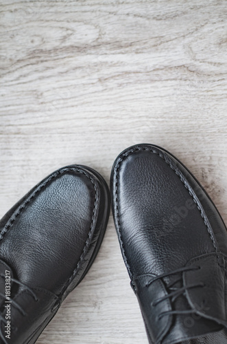 A pair of luxury black shoes close up on wood background photo