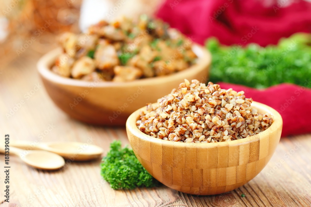Buckwheat in a wooden bowl and fresh vegetables Buckwheat in a wooden bowl and fresh vegetables
